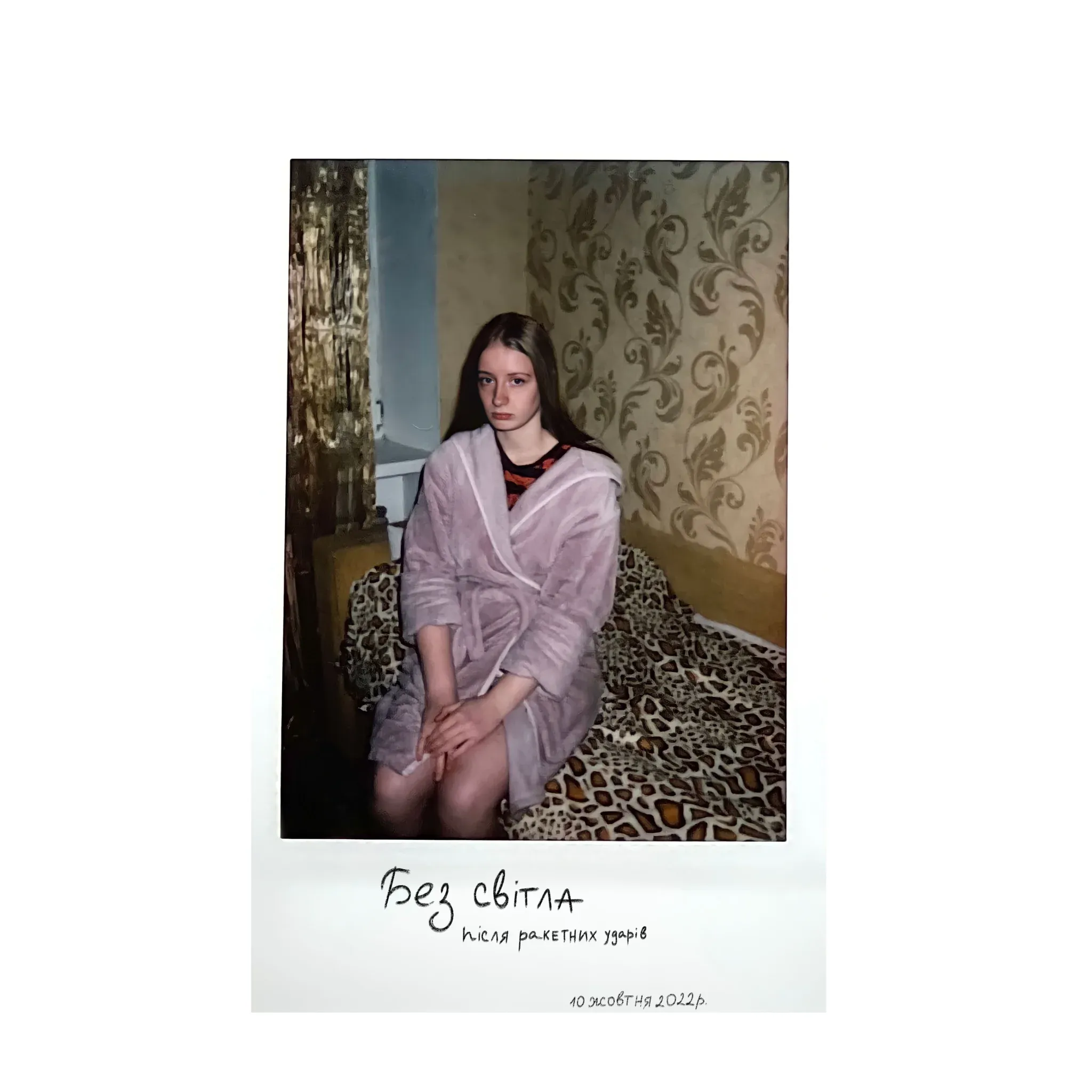 Polaroid of a young woman in a dressing gown in a dark room