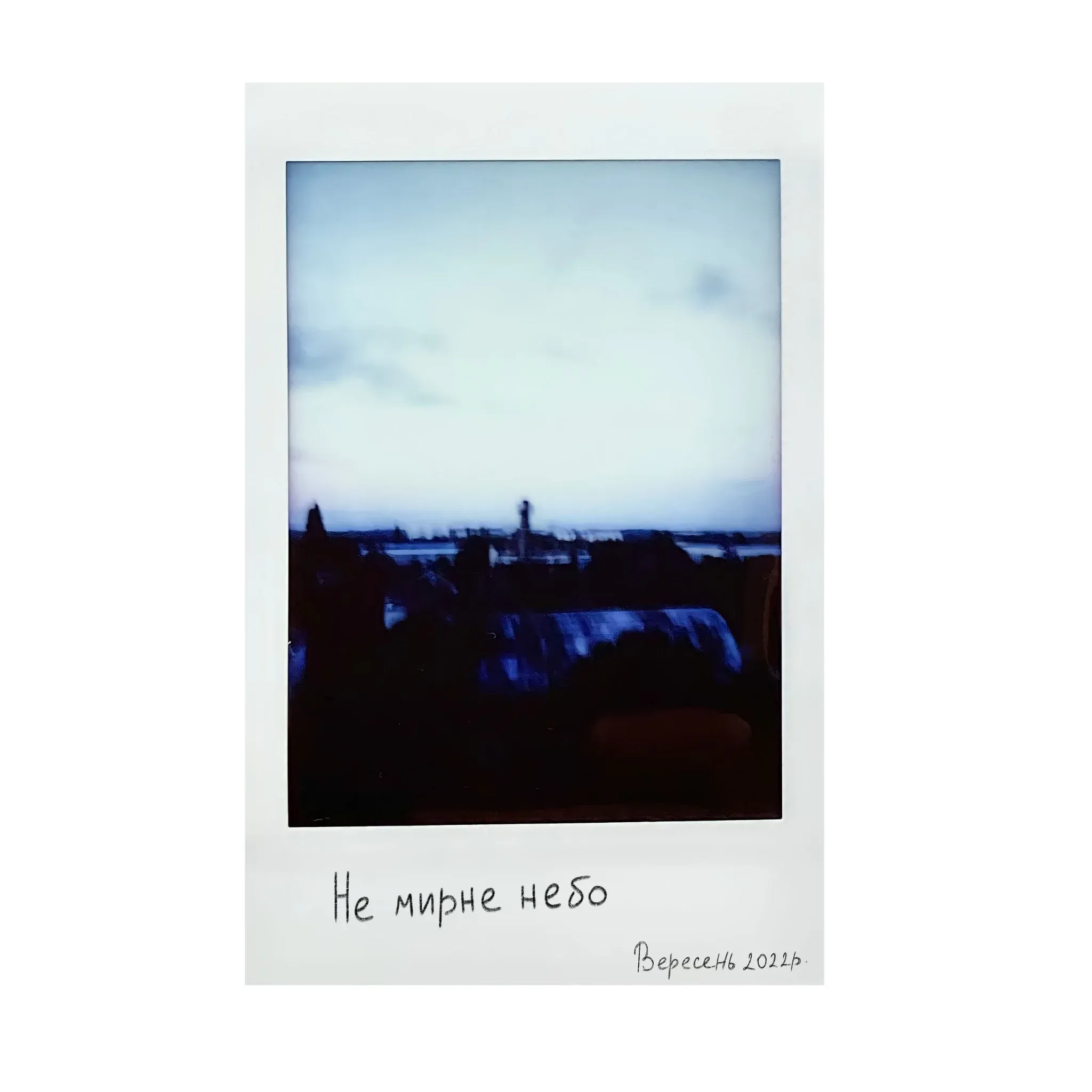 Polaroid of a grey sky over the city