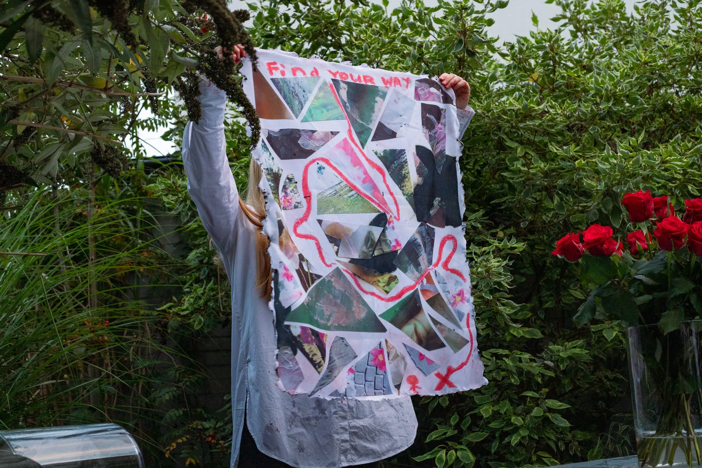 Holding up a collage page from the art book