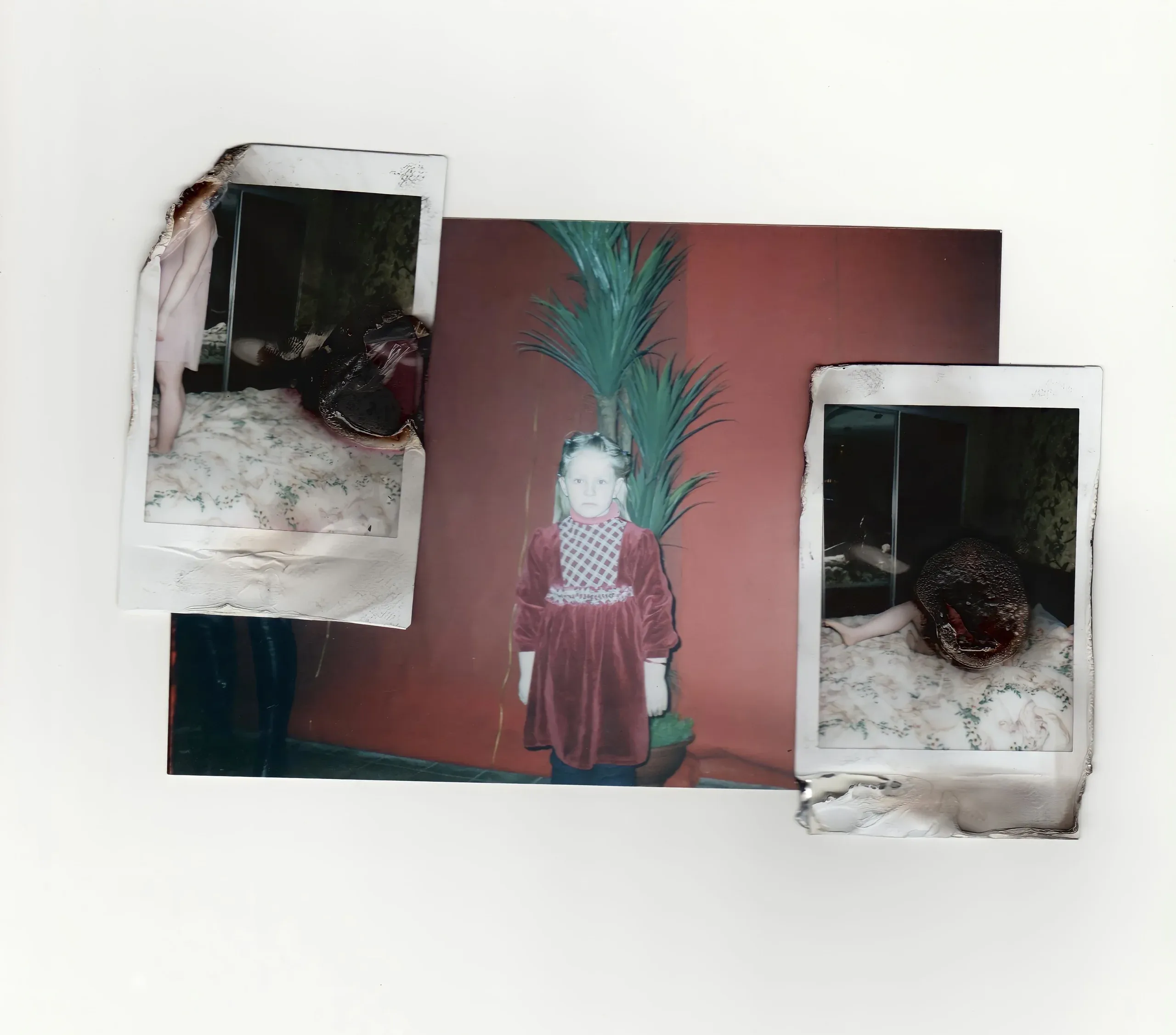 A child in a red dress between two burnt polaroids